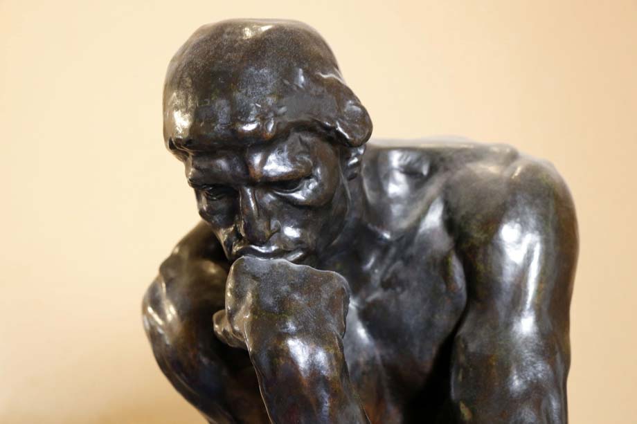 A sculpture of a man thinking deeply