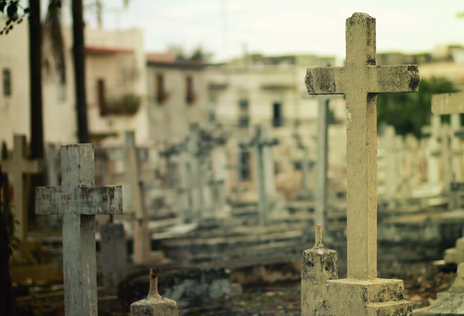 A cemetery with crosses on the graves