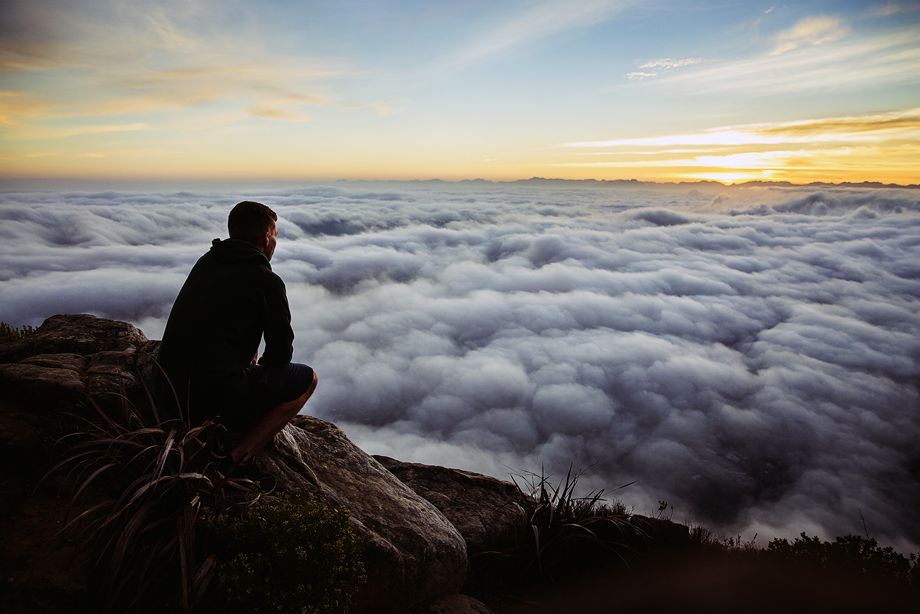 A man thinking looking at the sunrise